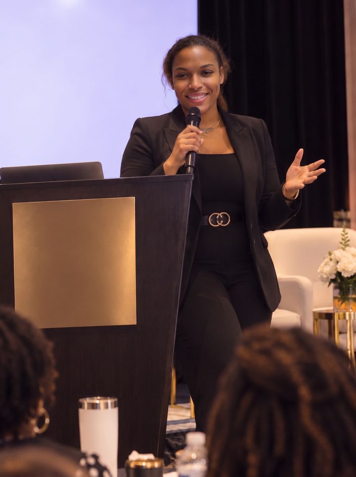 Dr. Gee at a podium presenting to the audience