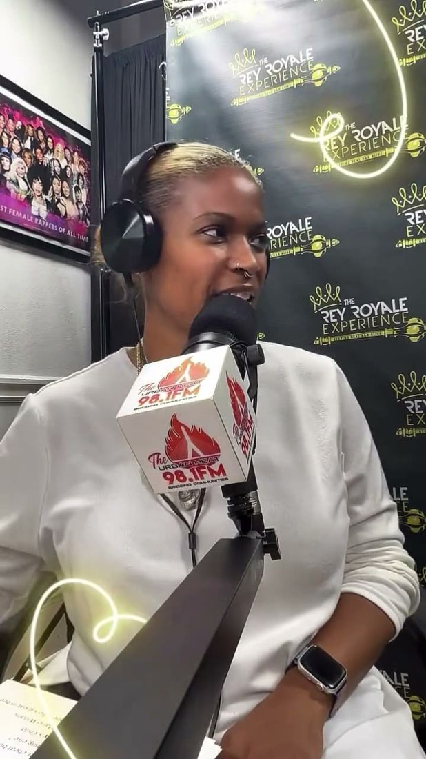 Dr. Gee in headphones at the Urban Heat 98.1 FM microphone in The Rey Royale Experience studio