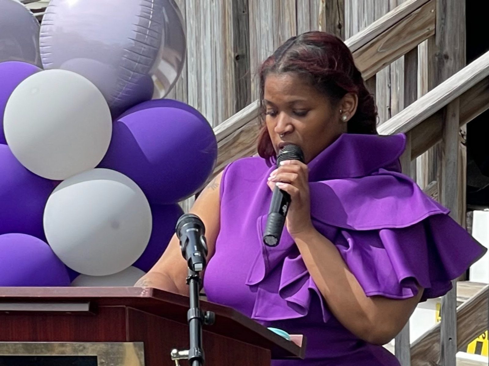 Dr. Guan Q. Ellerbe speaking at a podium